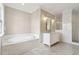 This bathroom features a tub, white marble countertops, a tile shower and neutral paint at 565 Stone Field Nw Run, Marietta, GA 30060