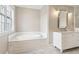 Modern bathroom features a built-in tub and a white marble top vanity at 565 Stone Field Nw Run, Marietta, GA 30060