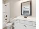 Bathroom with white vanity, framed mirror, and shower and tub combination with classic bronze plumbing fixtures at 565 Stone Field Nw Run, Marietta, GA 30060