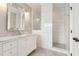 Spacious bathroom featuring tile flooring, a tile shower, and a vanity with white marble countertop at 565 Stone Field Nw Run, Marietta, GA 30060