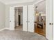 Open doors provide access from a carpeted bedroom to the bathroom and kitchen area at 565 Stone Field Nw Run, Marietta, GA 30060