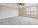 Spacious carpeted bedroom features a modern ceiling fan, crown moulding and natural light at 565 Stone Field Nw Run, Marietta, GA 30060