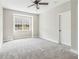 Bedroom showcasing a ceiling fan, window, and plush carpeting, creating a cozy and inviting atmosphere at 565 Stone Field Nw Run, Marietta, GA 30060
