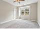 Bedroom showcasing a ceiling fan, window, and plush carpeting, creating a cozy and inviting atmosphere at 565 Stone Field Nw Run, Marietta, GA 30060