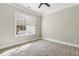 Carpeted bedroom with a large window, providing natural light and a view to the outside at 565 Stone Field Nw Run, Marietta, GA 30060