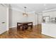 Open dining area with a rustic wooden table and bench seating next to the kitchen at 565 Stone Field Nw Run, Marietta, GA 30060
