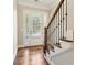 Elegant home entryway featuring hardwood floors, staircase and a door with sidelight windows at 565 Stone Field Nw Run, Marietta, GA 30060