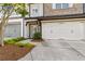 Charming townhome featuring an attached two-car garage and meticulously maintained landscaping at 565 Stone Field Nw Run, Marietta, GA 30060