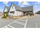 Charming building with outdoor seating area, red umbrellas, and peaked roofs with blue trim accents at 565 Stone Field Nw Run, Marietta, GA 30060