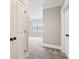 Hallway shows the access to a carpeted bedroom with neutral paint and decor at 565 Stone Field Nw Run, Marietta, GA 30060