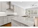 Spacious kitchen with a large center island, white countertops, and stainless steel appliances at 565 Stone Field Nw Run, Marietta, GA 30060