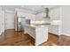 Bright kitchen with white cabinets, stainless steel appliances, and hardwood floors at 565 Stone Field Nw Run, Marietta, GA 30060