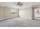Large carpeted main bedroom features a window, neutral paint and a view to an ensuite at 565 Stone Field Nw Run, Marietta, GA 30060