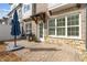 Private patio with a brick walkway, stone wall, grill, and partial view of the main home at 565 Stone Field Nw Run, Marietta, GA 30060