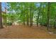 Serene backyard with mature trees, offering a peaceful and private outdoor space at 1100 Kensington Ct, Johns Creek, GA 30022