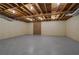 Spacious unfinished basement with exposed ceiling and brick feature wall, ready for customization at 1100 Kensington Ct, Johns Creek, GA 30022