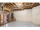 Unfinished basement featuring concrete floor and open ceiling with visible pipes and utilities at 1100 Kensington Ct, Johns Creek, GA 30022