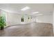 Spacious basement with wood-look floors, white walls, and natural light from multiple windows at 1100 Kensington Ct, Johns Creek, GA 30022