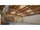Unfinished basement with exposed ceiling and open framework, offering potential for renovation at 1100 Kensington Ct, Johns Creek, GA 30022