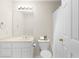 Bright bathroom featuring a vanity, toilet, and shower with a white curtain at 1100 Kensington Ct, Johns Creek, GA 30022