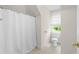 Bright bathroom featuring a shower with a white curtain and a window with natural light at 1100 Kensington Ct, Johns Creek, GA 30022