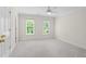Bedroom with neutral walls, carpeted floors, a ceiling fan, and two windows at 1100 Kensington Ct, Johns Creek, GA 30022
