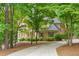 Beautiful brick home with mature trees surrounding the property at 1100 Kensington Ct, Johns Creek, GA 30022