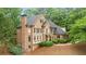 Elegant brick home with a well-maintained lawn and mature trees offers great curb appeal at 1100 Kensington Ct, Johns Creek, GA 30022