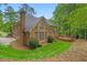 Beautiful brick home featuring a spacious wooden deck and a well-manicured lawn at 1100 Kensington Ct, Johns Creek, GA 30022
