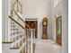 Inviting foyer featuring a grand staircase, hardwood floors, and elegant details at 1100 Kensington Ct, Johns Creek, GA 30022