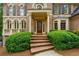 Beautiful brick home featuring a covered entry and well-manicured landscaping at 1100 Kensington Ct, Johns Creek, GA 30022