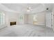 Large main bedroom featuring a fireplace, tray ceiling, and an adjoining bathroom at 1100 Kensington Ct, Johns Creek, GA 30022