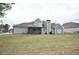 Back exterior of a two-story gray sided home featuring a screened in porch and well maintained lawn at 15 Worthington Dr, Villa Rica, GA 30180