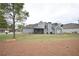 Back exterior of a two-story gray sided home featuring a screened in porch and well maintained lawn at 15 Worthington Dr, Villa Rica, GA 30180
