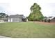 Spacious backyard with well-maintained lawn, side door and screened-in porch of a two-story gray sided home at 15 Worthington Dr, Villa Rica, GA 30180