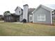 View of grey siding, screened porch with furnishings and outdoor grill in a relaxing backyard at 15 Worthington Dr, Villa Rica, GA 30180