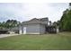 Spacious backyard with well-maintained lawn and screened-in porch of a two-story gray sided home at 15 Worthington Dr, Villa Rica, GA 30180