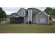 A relaxing backyard featuring grey siding, a screened porch and an outdoor grill at 15 Worthington Dr, Villa Rica, GA 30180
