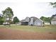 Spacious backyard featuring a screened porch and well-maintained lawn and grey siding at 15 Worthington Dr, Villa Rica, GA 30180