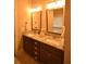 Bright bathroom featuring double sinks, granite countertops, and warm lighting at 15 Worthington Dr, Villa Rica, GA 30180