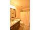 Bathroom featuring a granite countertop sink, toilet, and a shower with a curtain at 15 Worthington Dr, Villa Rica, GA 30180