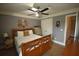 Cozy bedroom featuring ceiling fan, a dresser, and decorative items on the wall at 15 Worthington Dr, Villa Rica, GA 30180