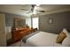 Bedroom with neutral walls, ceiling fan, and dresser with decorative items at 15 Worthington Dr, Villa Rica, GA 30180