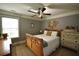 Cozy bedroom with neutral walls, ceiling fan, and dresser with decorative items at 15 Worthington Dr, Villa Rica, GA 30180