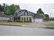 Charming two-story home with stone and siding, manicured lawn, and a two-car garage at 15 Worthington Dr, Villa Rica, GA 30180