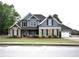 Charming two-story home featuring a stone and siding facade, a well-manicured lawn, and an attached two-car garage at 15 Worthington Dr, Villa Rica, GA 30180