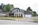 Two-story home featuring stone and siding, well-maintained lawn, two-car garage and extra parking on a concrete driveway at 15 Worthington Dr, Villa Rica, GA 30180