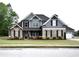 Beautiful two-story home featuring stone and siding, complemented by a lush front lawn and an attached two-car garage at 15 Worthington Dr, Villa Rica, GA 30180