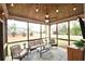 Cozy screened-in porch with wicker furniture, ceiling fan, string lights, and views of the backyard at 15 Worthington Dr, Villa Rica, GA 30180