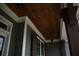 Close up of a covered porch featuring dark wood ceiling and exposed support beams at 15 Worthington Dr, Villa Rica, GA 30180